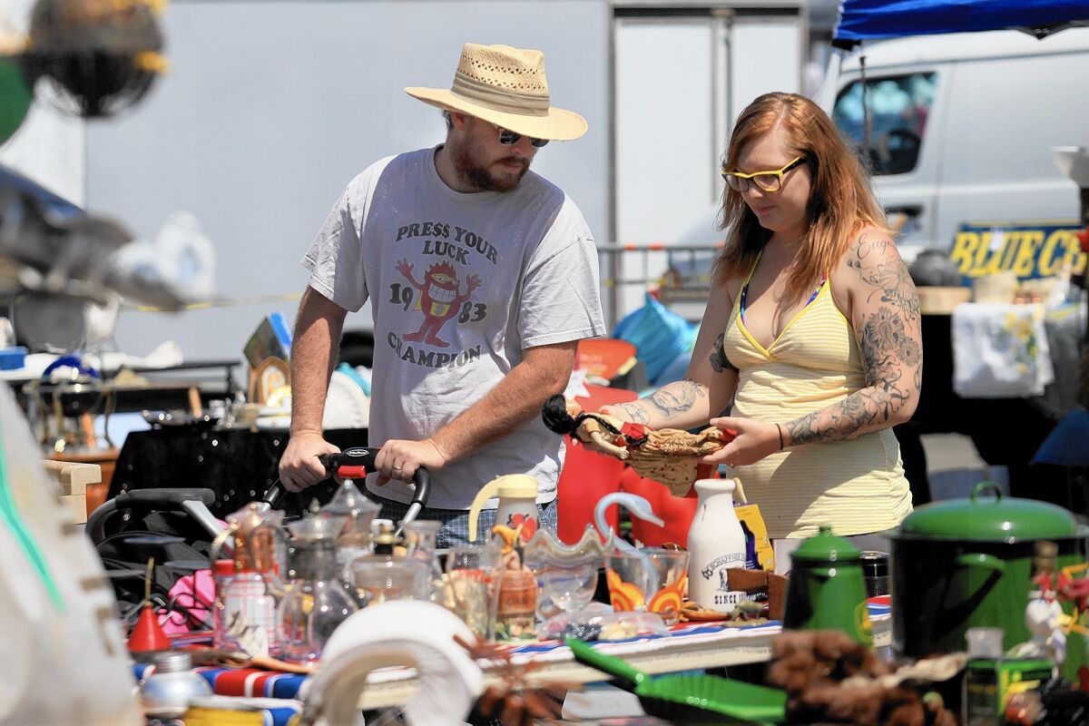 Shoppers peruse offerings at the Orange County Market Place at the fairgrounds in Costa Mesa.