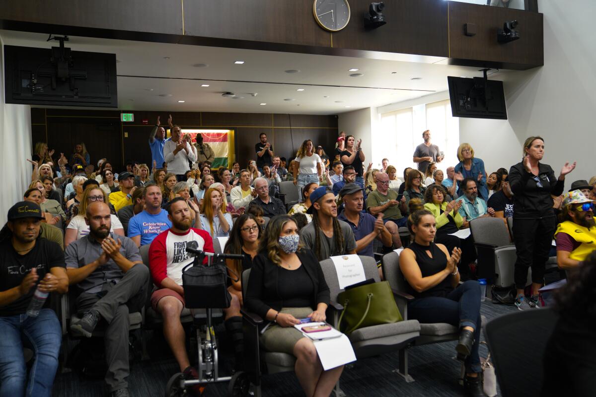 A crowd cheers a critic of the county Board of Supervisors' plan to declare medical misinformation a public health crisis.