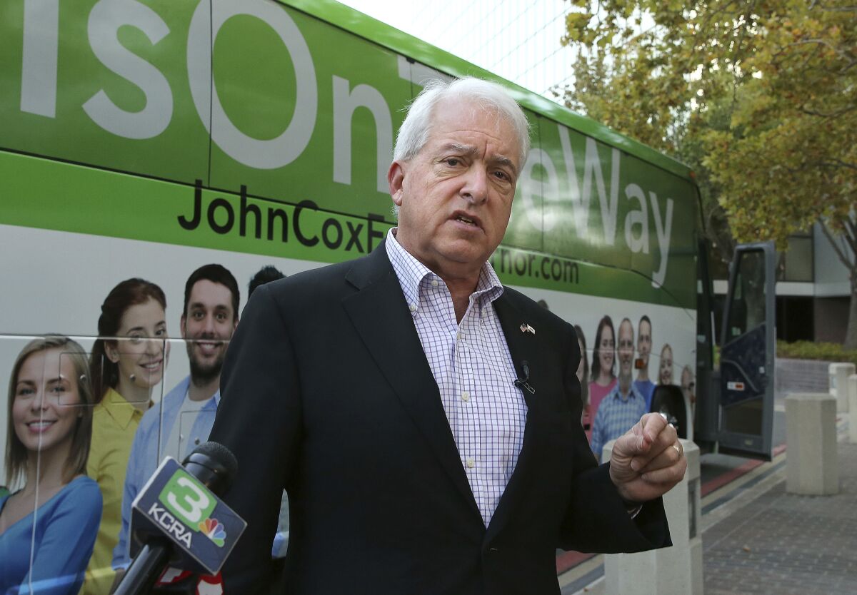 FILE - In this Nov. 1, 2018, file photo, Republican gubernatorial candidate John Cox talks to reporters before beginning a statewide bus tour in Sacramento, Calif. Cox who is running in California's recall election, announced a proposal on Monday June 28, 2021, to tackle the California's homeless problem. His plan includes forcing people to get treatment for mental health issues and stepping up enforcement against people living on the streets.(AP Photo/Rich Pedroncelli, File)
