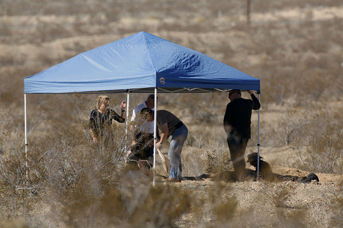 San Bernardino County Sheriff's Department investigators excavate a grave on the outskirts of Victorville that contained the skeletal remains of multiple people.