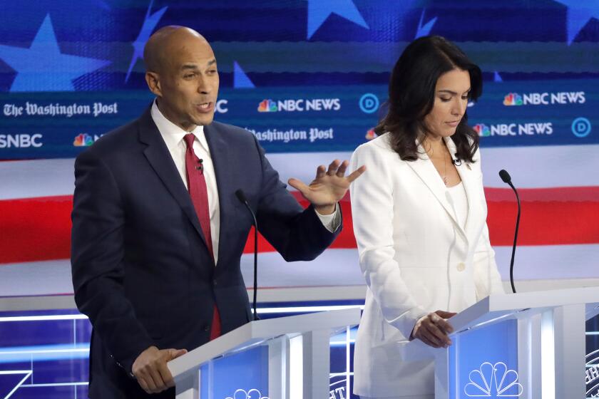 ATLANTA, GEORGIA - NOVEMBER 20: Democratic presidential candidate Sen. Cory Booker (D-NJ) speaks as Rep. Tulsi Gabbard (D-HI) listens during the Democratic Presidential Debate at Tyler Perry Studios November 20, 2019 in Atlanta, Georgia. Ten Democratic presidential hopefuls were chosen from the larger field of candidates to participate in the debate hosted by MSNBC and The Washington Post. (Photo by Alex Wong/Getty Images) ** OUTS - ELSENT, FPG, CM - OUTS * NM, PH, VA if sourced by CT, LA or MoD **