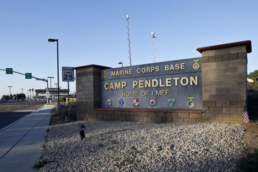 FILE - This Nov. 13, 2013, file photo shows the main gate of Camp Pendleton Marine Base at Camp Pendleton, Calif. Marine Corps prosecutors were scrambling Tuesday, Nov. 19, 2019, to save their numerous cases against Marines accused in a human smuggling and drug investigation after a military judge ruled it was illegal to arrest them during a morning battalion formation. (AP Photo/Lenny Ignelzi, File)