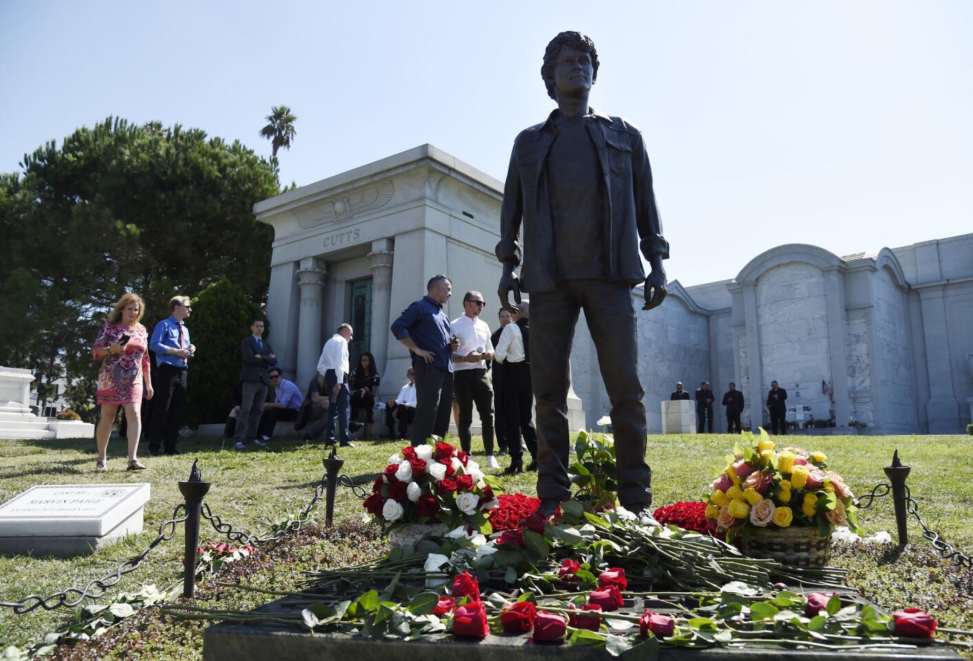 Guests gather around a statue of the late actor Anton Yelchin during a life celebration and statue unveiling for Yelchin at Hollywood Forever Cemetery in Los Angeles. Yelchin died in June 2016 at the age of 27.