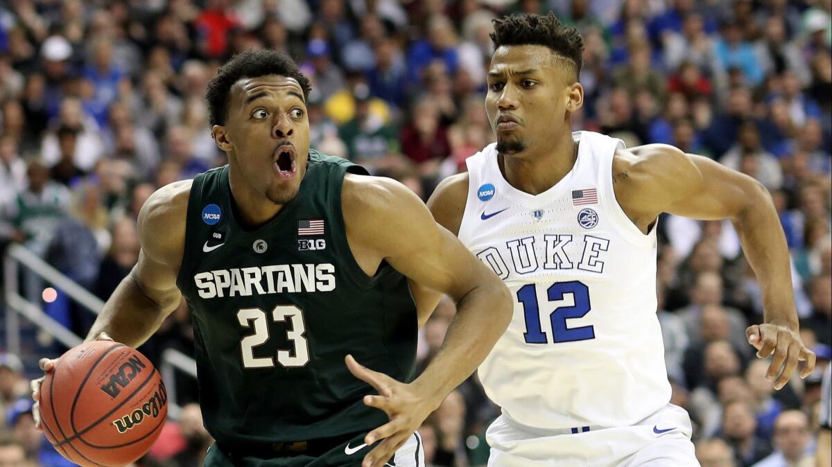 Michigan State's Xavier Tillman tries to drive past Duke's Javin DeLaurier during the Spartans' victory Sunday.