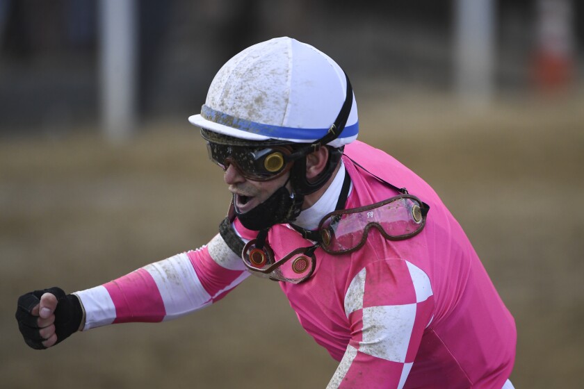 Flavien Prat atop Rombauer reacts after winning the 146th Preakness Stakes horse race at Pimlico Race Course, Saturday, May 15, 2021, in Baltimore. (AP Photo/Will Newton)