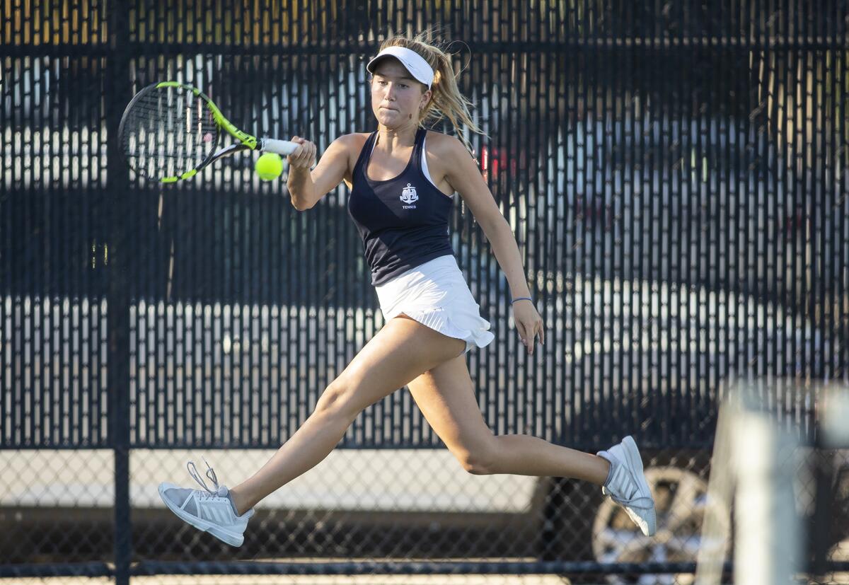 Newport Harbor's Kristin Lindh returns a shot in a Battle of the Bay match against Corona del Mar on Tuesday.