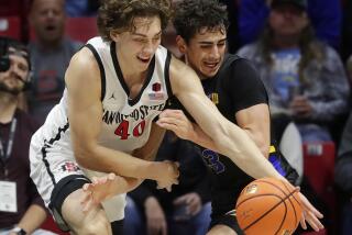 San Diego CA - February 27: San Diego State's Miles Heide battles for the ball after blocking a shot by San Jose State's Alvaro Cardenas at Viejas Arena on February, 2024 in San Diego, CA. (K.C. Alfred / The San Diego Union-Tribune)