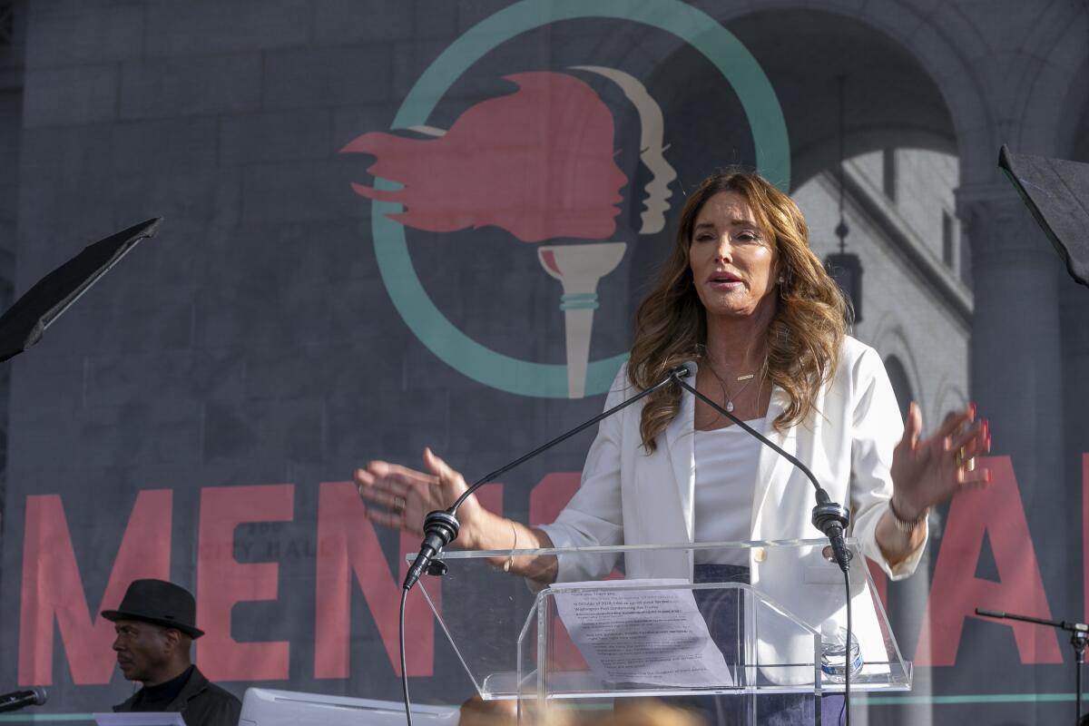 Caitlyn Jenner speaks into microphones.