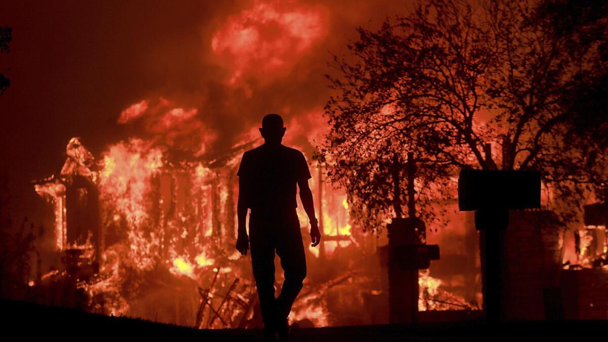 A homeowner in Fountaingrove watches his neighborhood burn in wildfires in California's wine country.