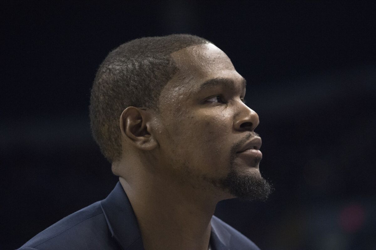 Thunder forward Kevin Durant watches game action against the New Orleans Pelicans from the bench.