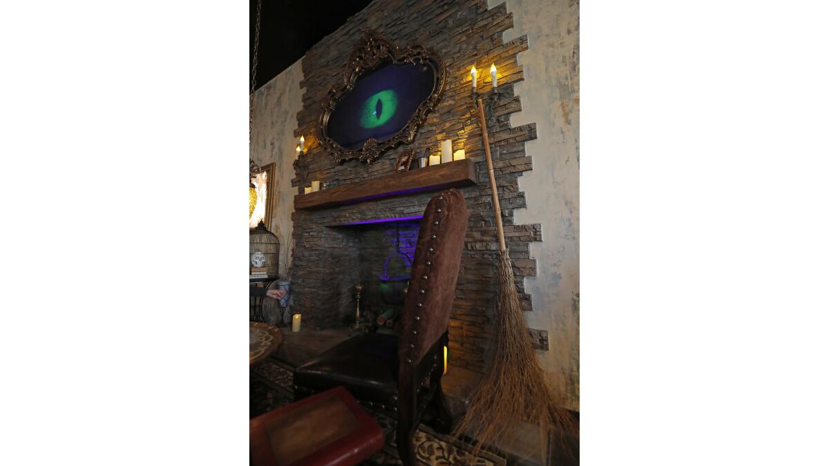 A haunted mirror above the fireplace at the Cauldron Spirit and Brews bar and restaurant in Buena Park.