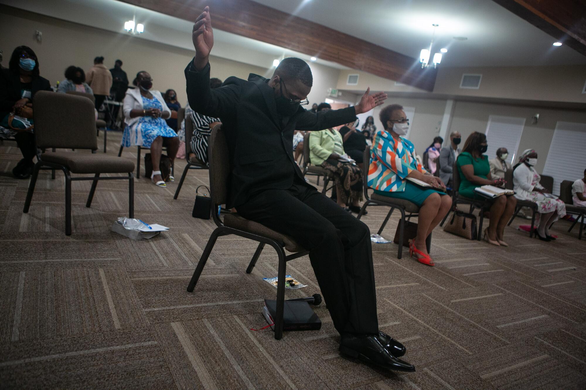 A church minister with hands raised 
