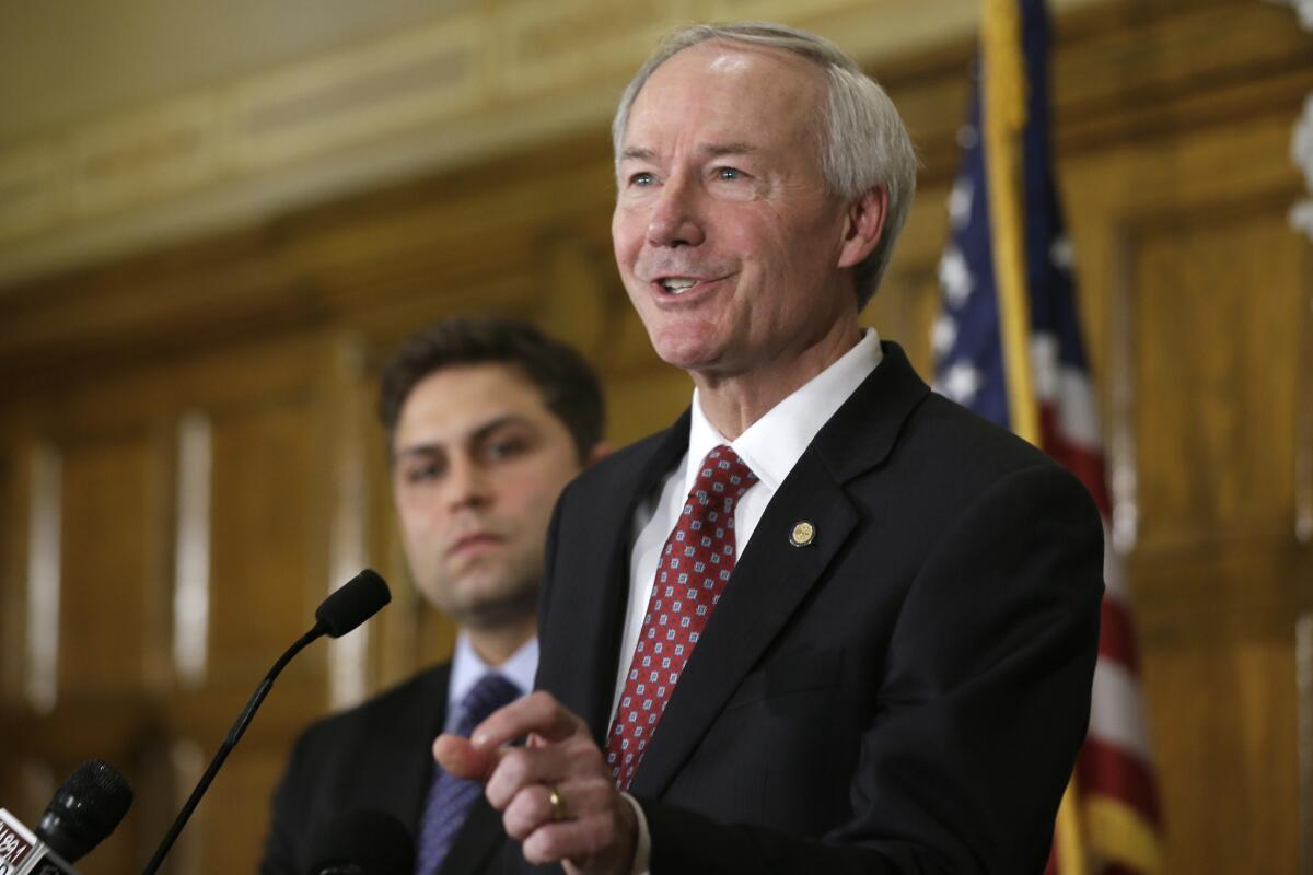 Arkansas Gov. Asa Hutchinson answers reporters' questions at the state Capitol in Little Rock on Wednesday.