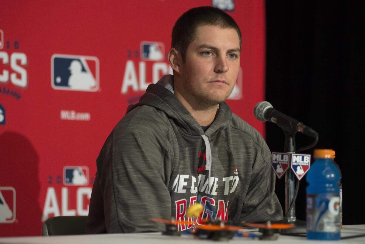 Indians pitcher Trevor Bauer discusses a recent injury to his finger caused by a drone, bottom, during a news conference in Torontoon Oct. 16.