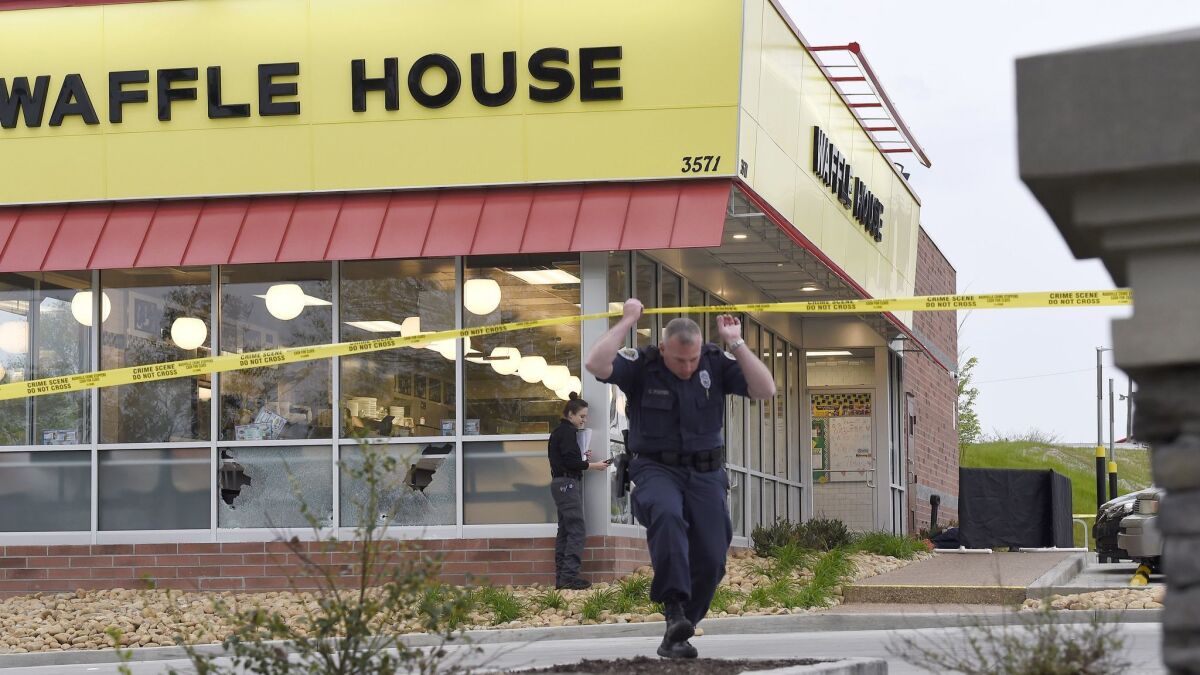 Law enforcement officials at the scene of a fatal shooting at a Nashville Waffle House on Sunday.
