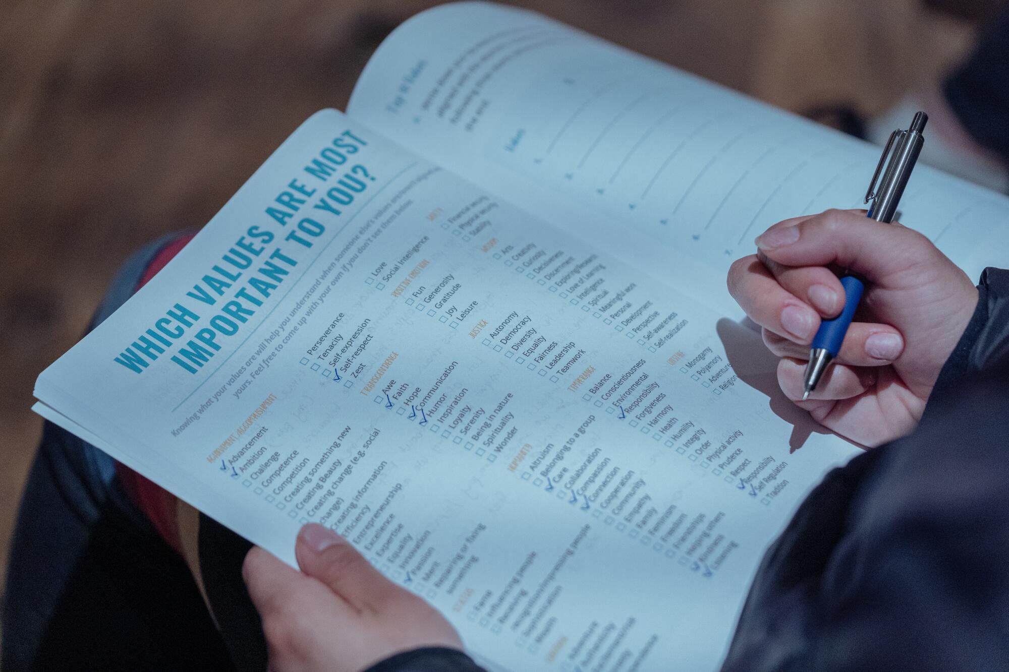 A hand writing in a notebook.