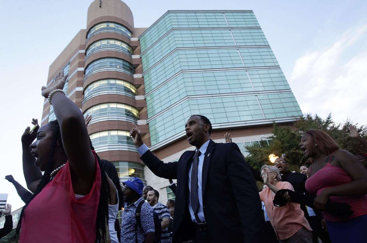 Pastors and protesters march to the office building of St. Louis County Prosecutor Robert McCullough in Clayton, Mo., on Aug. 20, demanding justice in the police shooting of Michael Brown.