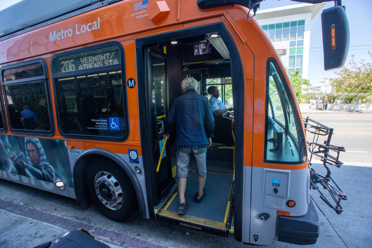 A man boards a bus in Koreatown.