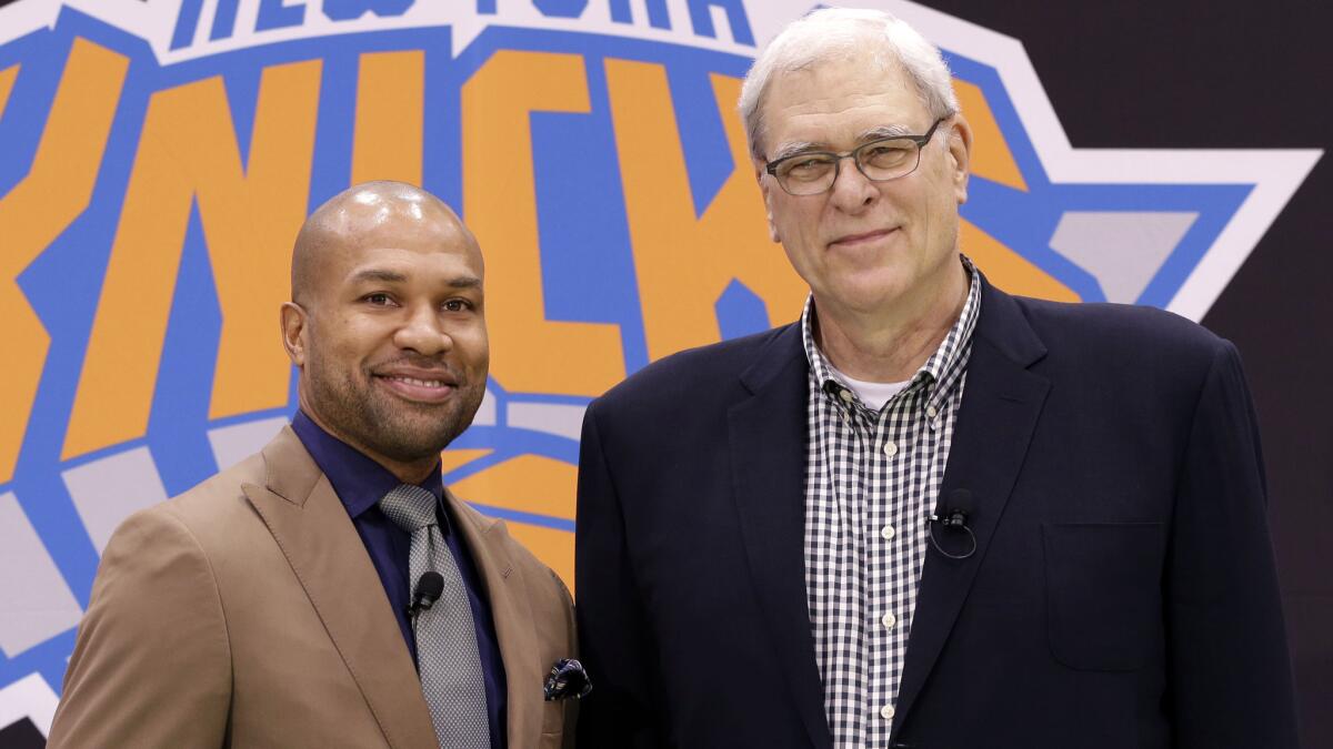 New York Knicks Coach Derek Fisher, left, and Knicks President Phil Jackson pose during a June 10 news conference.