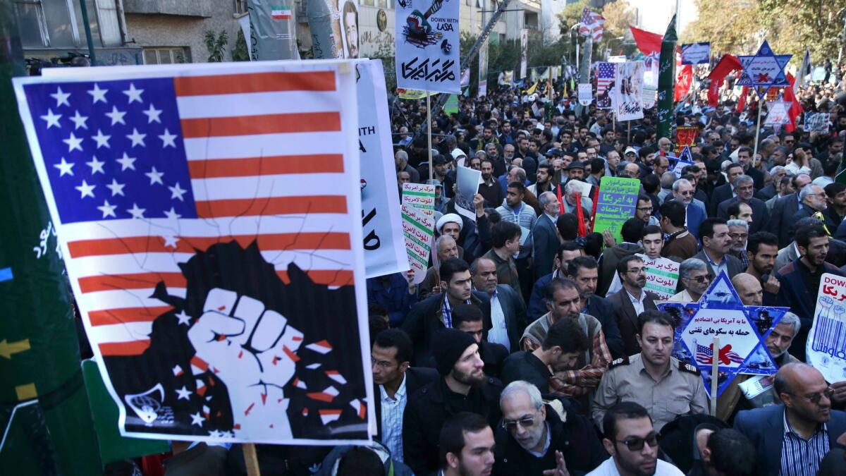 Holding anti-U.S. placards, Iranians attend a state-organized annual rally Nov. 3 in front of the former U.S. Embassy in Tehran.