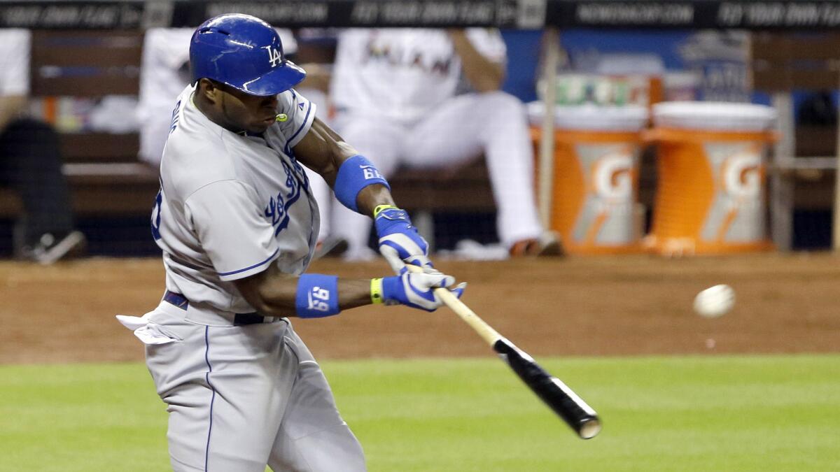 Dodgers right fielder Yasiel Puig hits a three-run home run during the fourth inning of a 9-7 win over the Miami Marlins on Saturday.