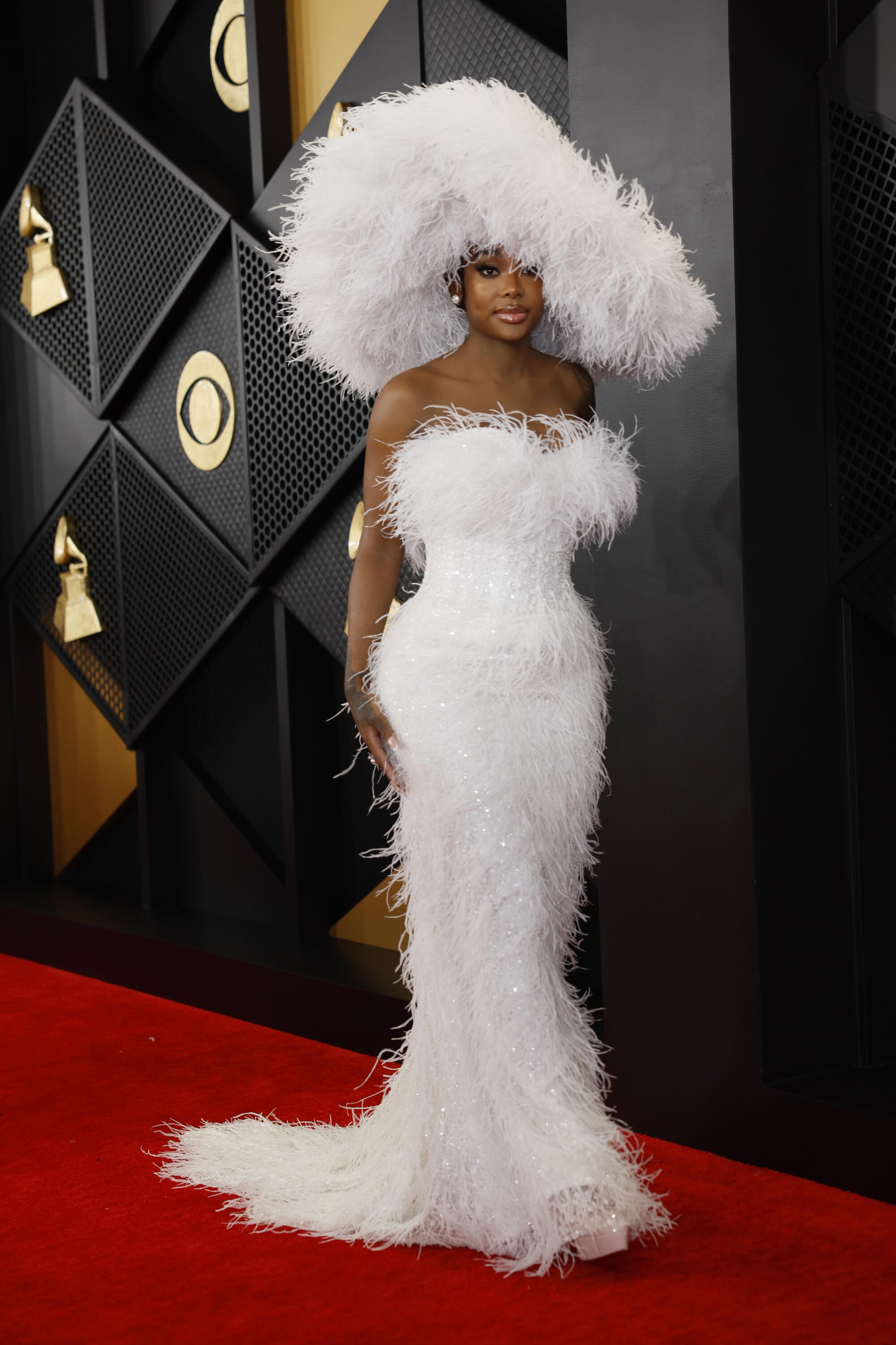 Summer Walker wears a white feather dress and hat 