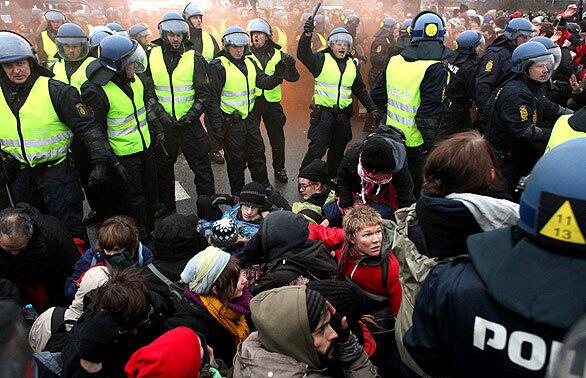Danish police clash with environmental activists at the United Nations Climate Change Conference in front of the Bella Convention Center in Copenhagen, Denmark.
