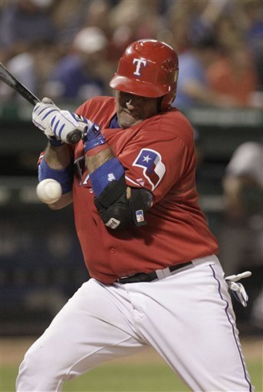 Texas Rangers Bengie Molina is hit by a pitch in the fourth inning of the baseball game against the New York Yankees t in Arlington, Texas, Friday, Sept. 10, 2010. (AP Photo/LM Otero)