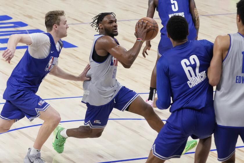 Bronny James (50), second from left, drives to the basket past Cam Spencer, left, during the 2024 NBA basketball Draft Combine in Chicago, Tuesday, May 14, 2024. (AP Photo/Nam Y. Huh)