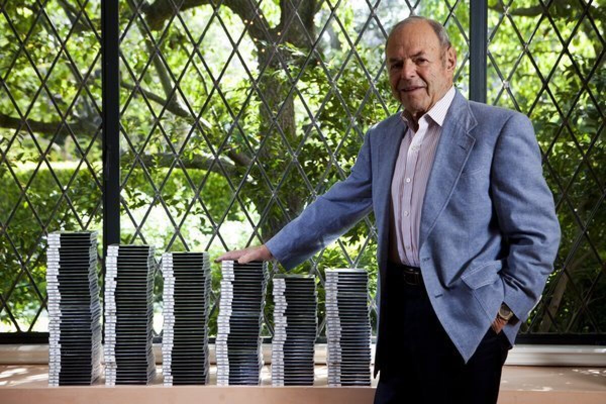 Veteran record executive Joe Smith with discs containing hundreds of hours of interviews he conducted in the 1980s and has donated to the Library of Congress.