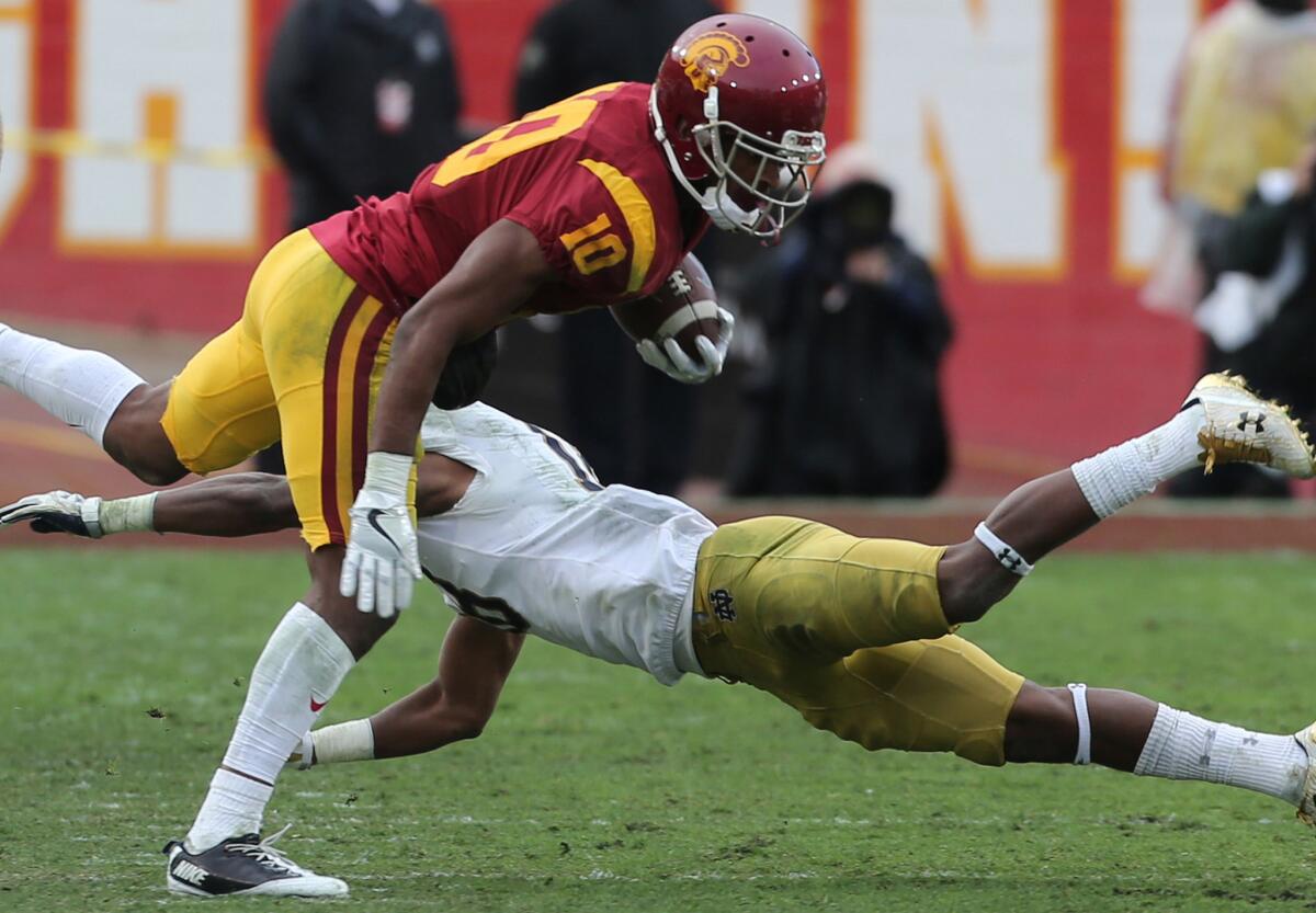 USC wide receiver Jalen Greene, shown dodging a Notre Dame defender on Nov. 26, spent his first season and a half at USC as a reserve quarterback behind Cody Kessler and Max Browne.