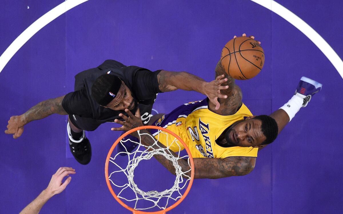 Lakers' Tarik Black shoots against Brooklyn's Trevor Booker on Nov. 15.