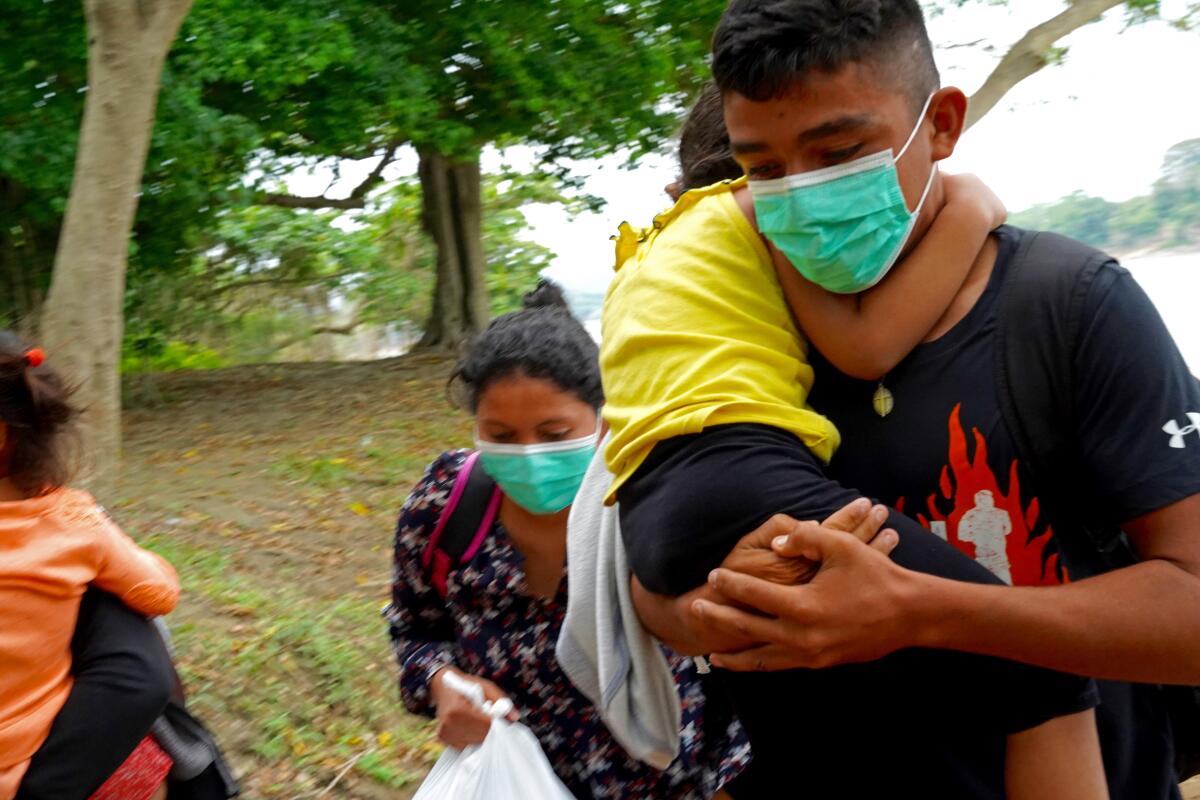 U.S.-bound Central American migrants arrive on the Mexican side of the Usumacinta River.