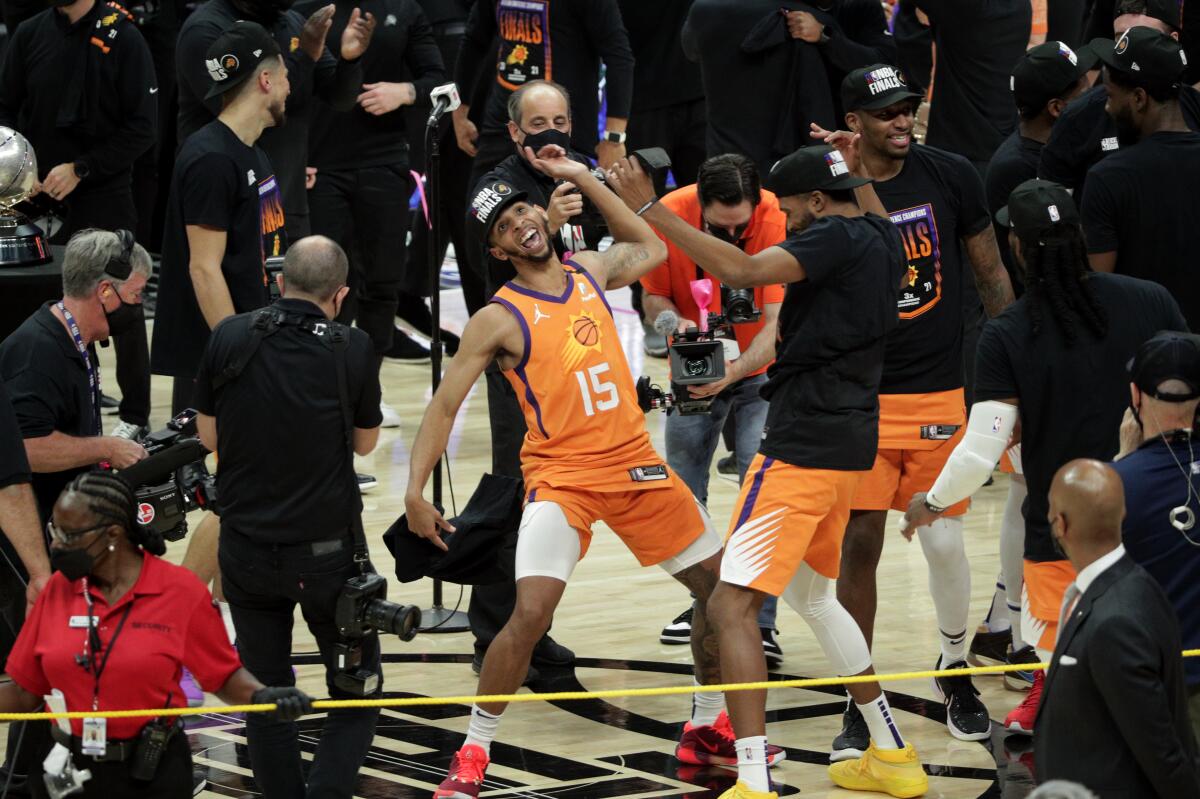Cameron Payne (15) dances with teammates after the Suns beat the Clippers to win the Western Conference finals.
