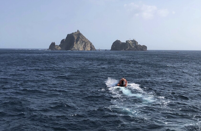 Rescue workers search for survivors on Friday after a South Korean ambulance helicopter crashed in waters off the country's eastern coast.