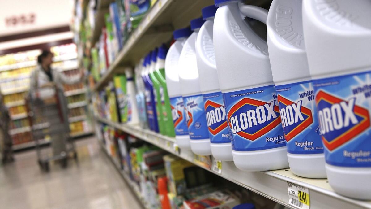 Bottles of Clorox bleach sit on a shelf at a grocery store.