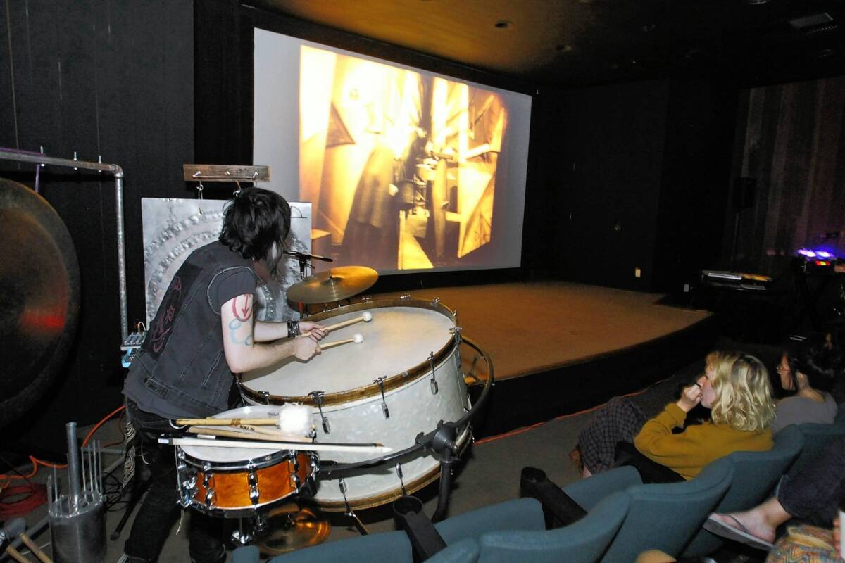 Michael Day, left, plays percussion as a 1920s German silent film is shown in film history class at the California Institute of the Arts.