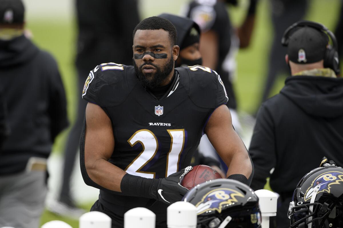 Baltimore Ravens running back Mark Ingram stands on the field.