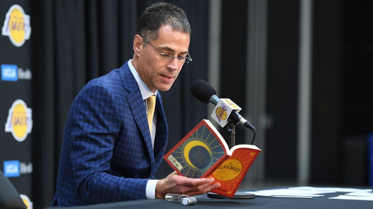 Lakers general manager Rob Pelinka reads a quote from "The Alchemist" during a news conference Wednesday in El Segundo.