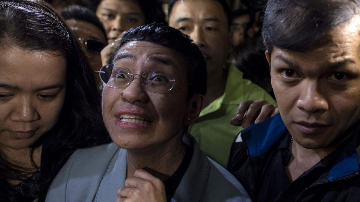 Journalist Maria Ressa arrives at a regional trial court in Manila to post bail Friday after being charged with cyber libel.