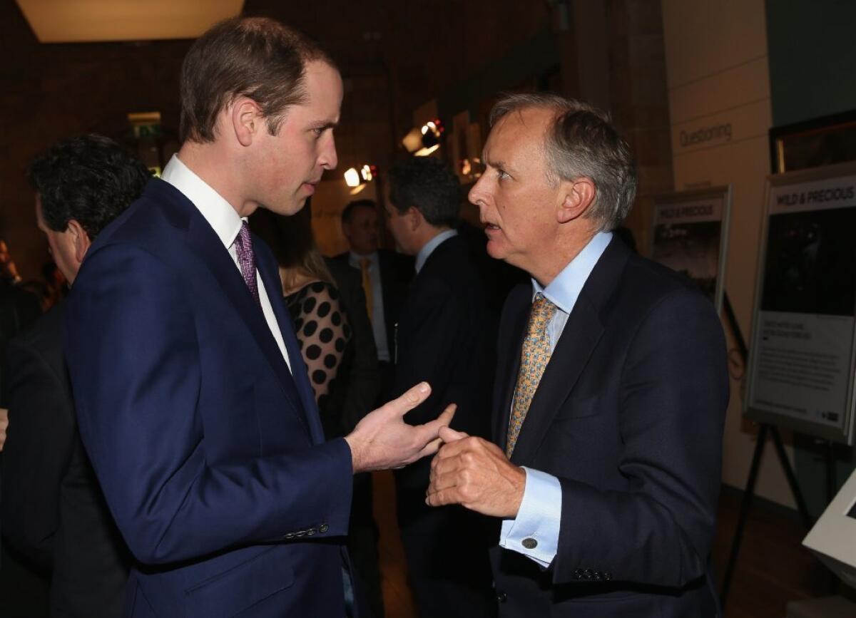 Prince William, the Duke of Cambridge, talks with Charlie Mayhew, head of the Tusk Trust organization, at an illegal wildlife trade conference at London's Natural History Museum.