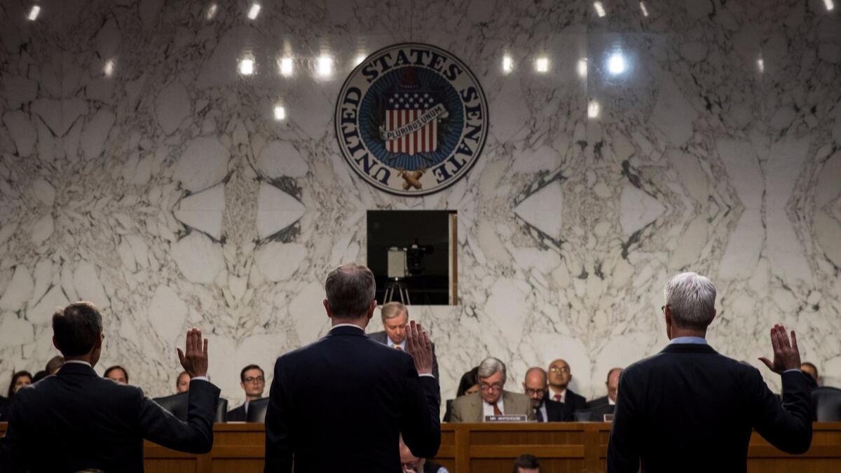 Richard Salgado, director of law enforcement and information security at Google, Sean Edgett, acting general counsel at Twitter, and Colin Stretch, general counsel at Facebook, are sworn-in during a hearing on Capitol Hill on Oct. 31.