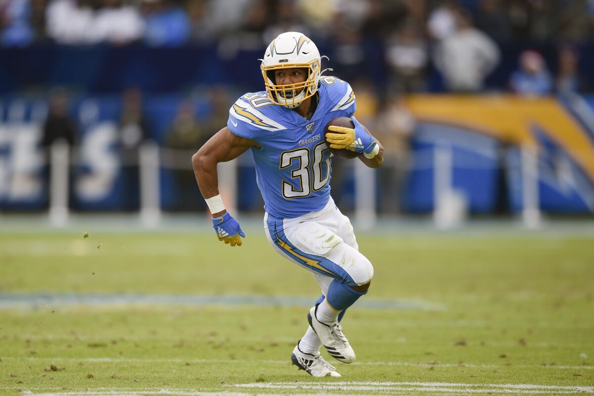 FILE - In this Dec. 22, 2019, file photo, Los Angeles Chargers running back Austin Ekeler runs against the Oakland Raiders during the second half of an NFL football game in Carson, Calif. Ekeler could be the one player who benefits the most from the Los Angeles Chargers changes on offense. (AP Photo/Kelvin Kuo, File)