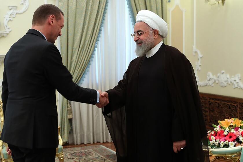 A handout picture provided by the Iranian presidency on July 10, 2019 Iran's President Hassan Rouhani (R) welcoming Emmanuel Bonne, diplomatic advisor to the French president, in the capital Tehran. - Iran has breached a uranium enrichment cap set by a troubled 2015 nuclear deal and warned Europe against taking retaliatory measures, as France decided to send an envoy to Tehran to try to calm tensions. (Photo by STRINGER / Iranian Presidency / AFP) / === RESTRICTED TO EDITORIAL USE - MANDATORY CREDIT "AFP PHOTO / HO / IRANIAN PRESIDENCY" - NO MARKETING NO ADVERTISING CAMPAIGNS - DISTRIBUTED AS A SERVICE TO CLIENTS ===STRINGER/AFP/Getty Images ** OUTS - ELSENT, FPG, CM - OUTS * NM, PH, VA if sourced by CT, LA or MoD **