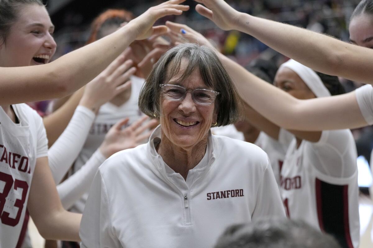 Stanford coach Tara VanDerveer smiles as players celebrate her 1,202nd victory as a college coach on Jan. 19, 2024