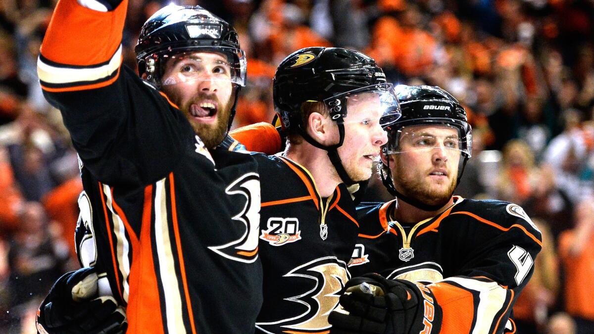 Ducks forward Patrick Maroon, left, celebrates with teammates Corey Perry, center, and Cam Fowler after scoring a goal in the Ducks' 3-1 loss to the Kings in Game 2 of the Western Conference semifinals at Honda Center on Monday.
