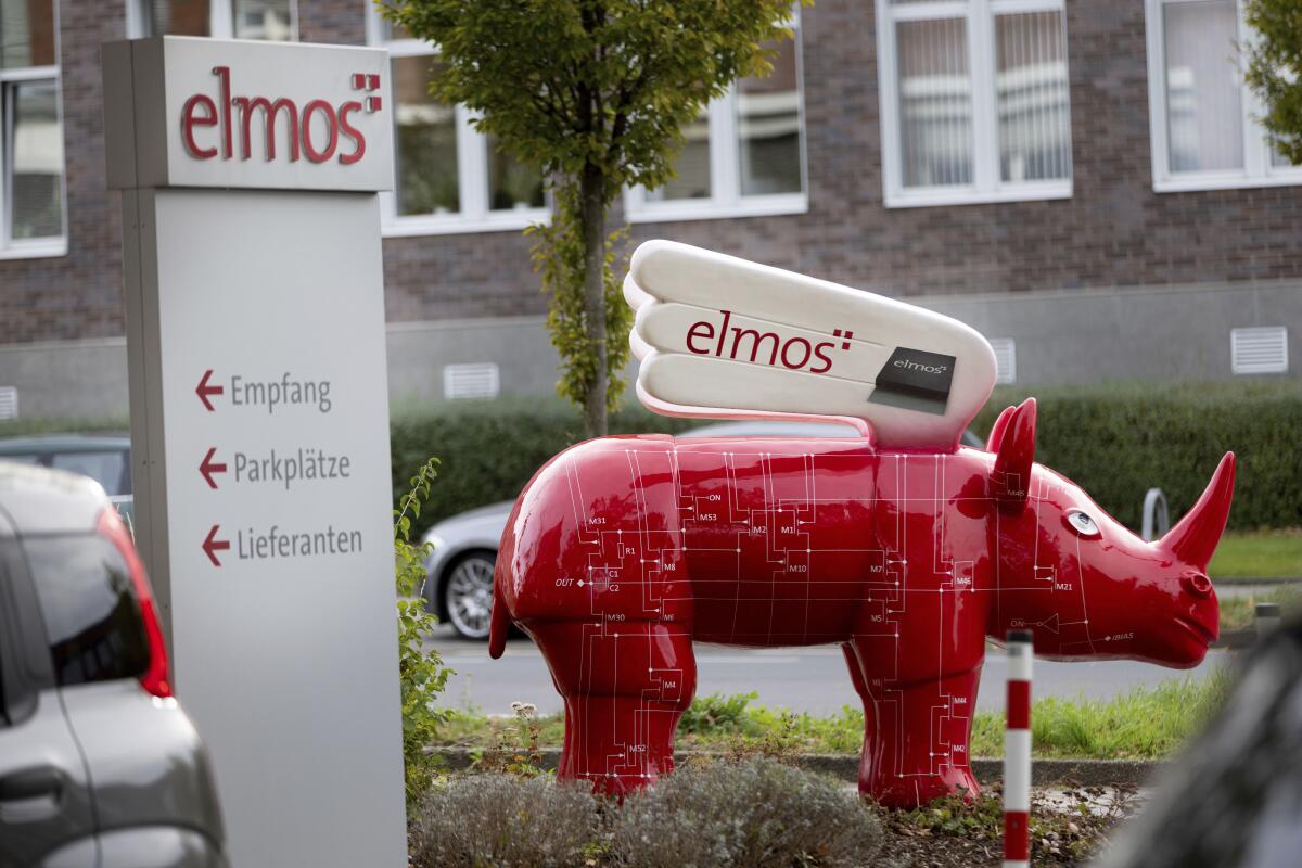 FILE - A winged 'Elmos rhinoceros' stands in front of the chip factory Elmos Semiconductor SE offices in Dortmund, Germany, on Nov. 8, 2022. China's government on Wednesday, Nov. 9, appealed to Germany to maintain access to its markets after the company said Berlin may block the sale of a computer chip factory to a Chinese-owned buyer amid tensions over technology and security. (Dieter Menne/dpa via AP, File)