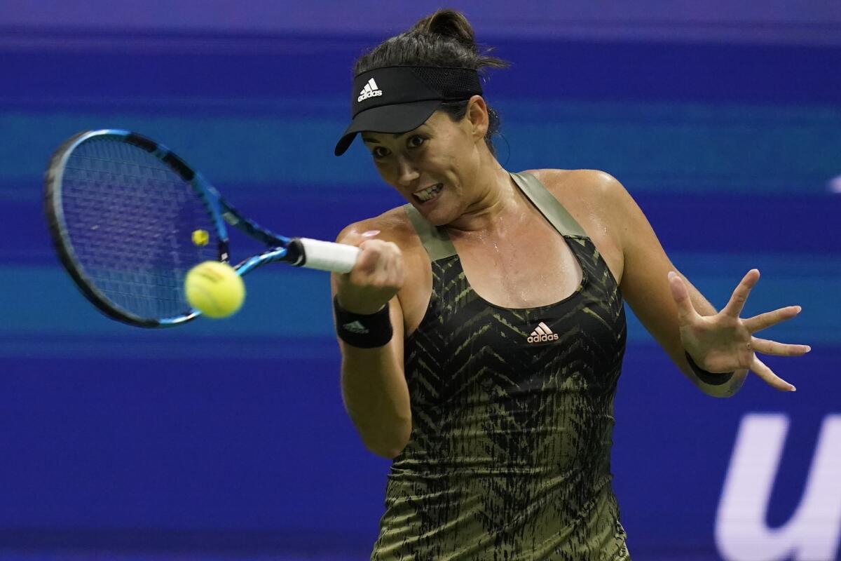 Garbine Muguruza returns a serve against Barbora Krejcikova