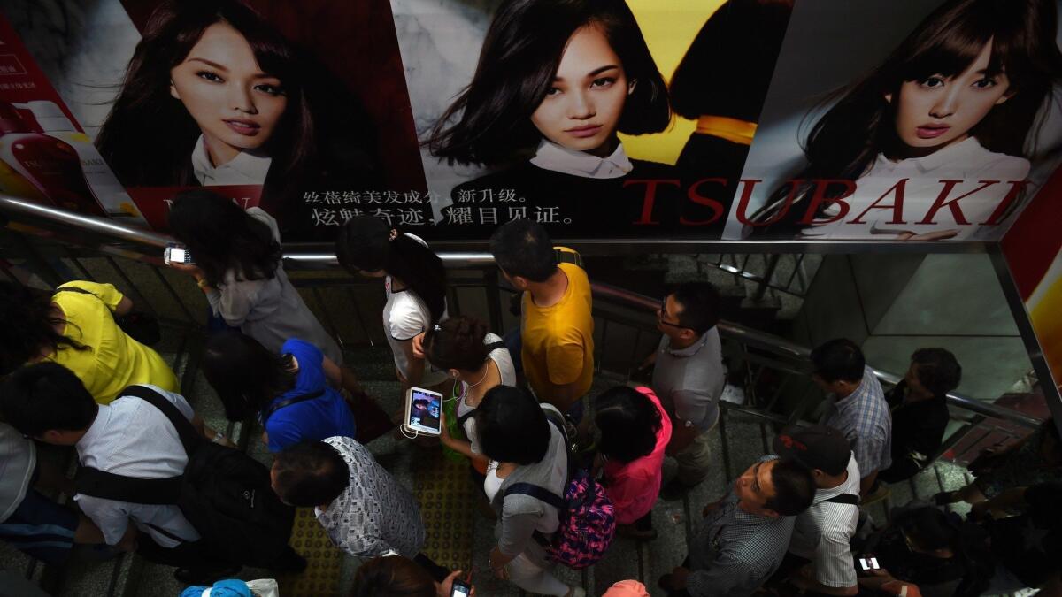 Commuters walk through a subway station in Beijing. China could add up to $2.6 trillion to annual GDP by 2025, a 13% jump, by improving gender parity, according to a 2018 report by McKinsey & Co.