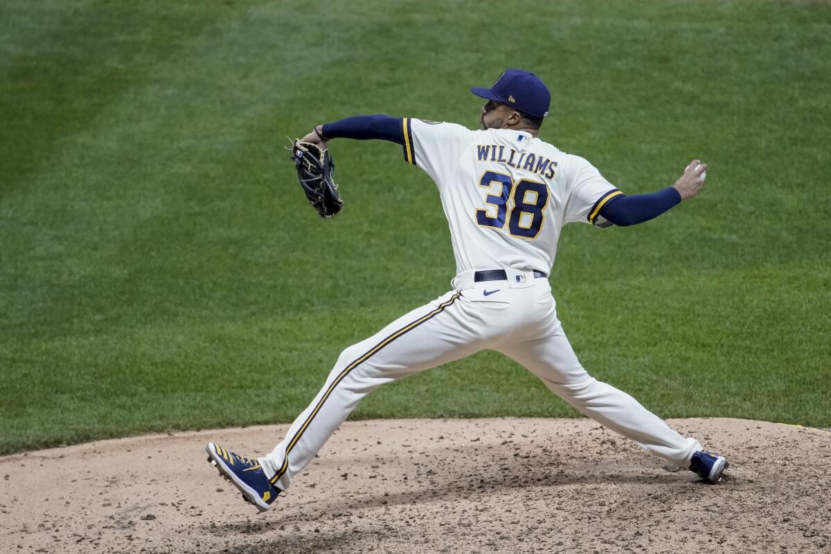Milwaukee Brewers relief pitcher Devin Williams delivers a pitch.